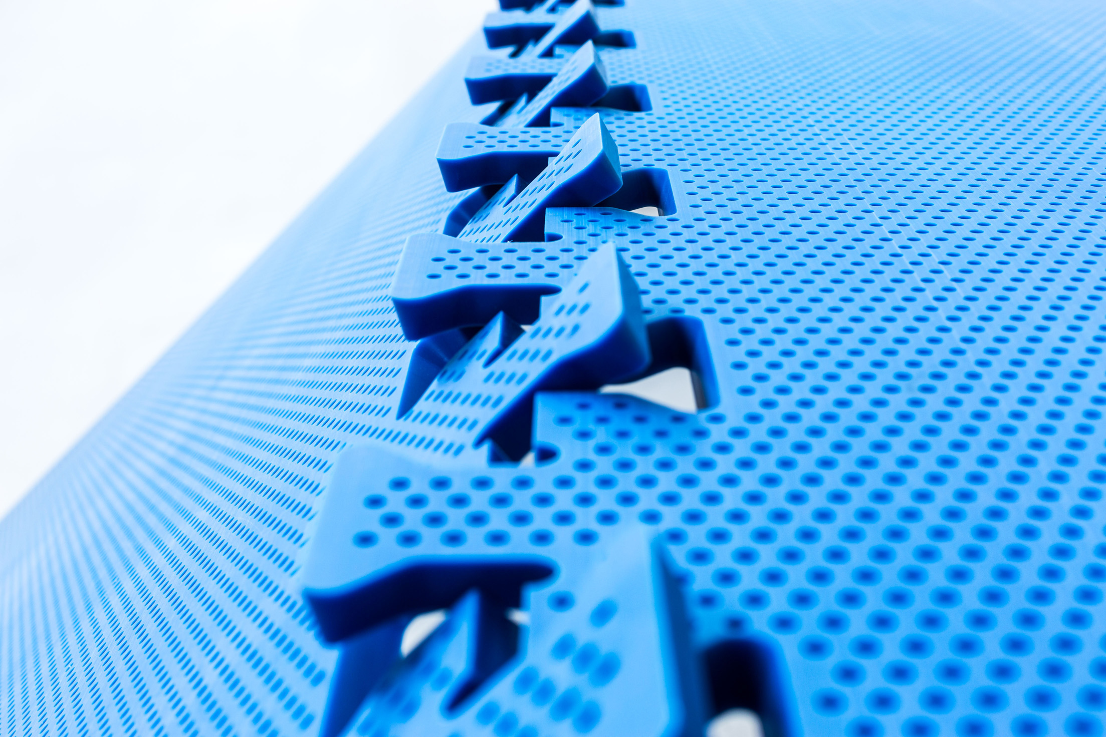 Close up of OctoFrost perforated blue bedplates with puzzle connection